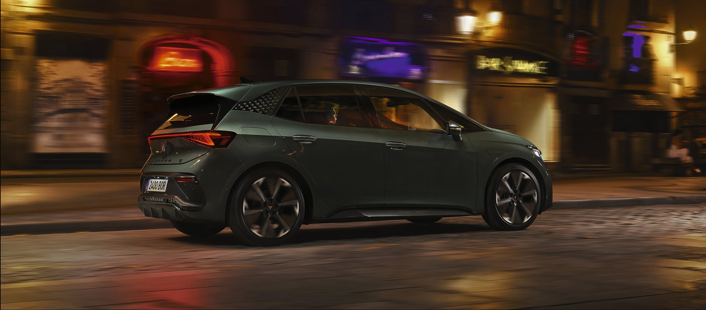 battery electric vehicle, cupra born with regenerative braking system being driven in the city at night